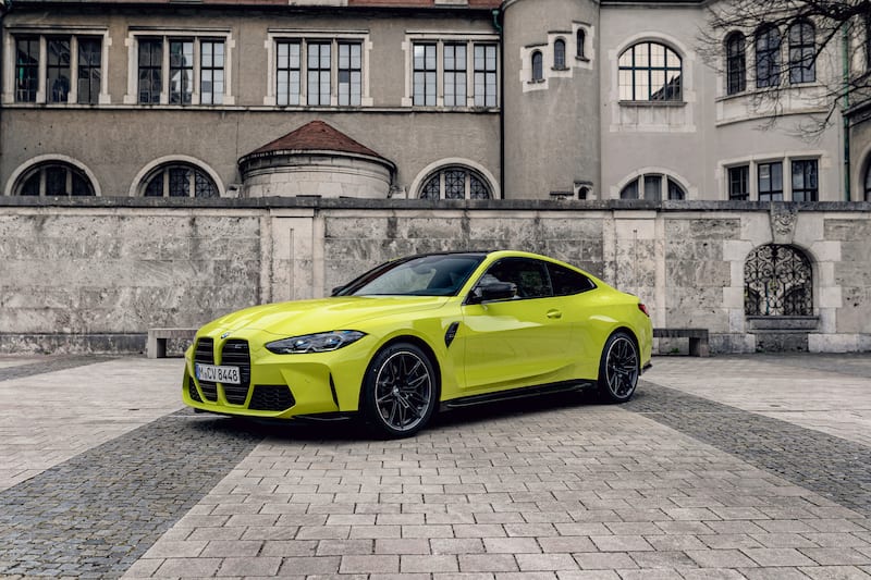 BMW M4 gelb Mietwagen auf schoenem Platz